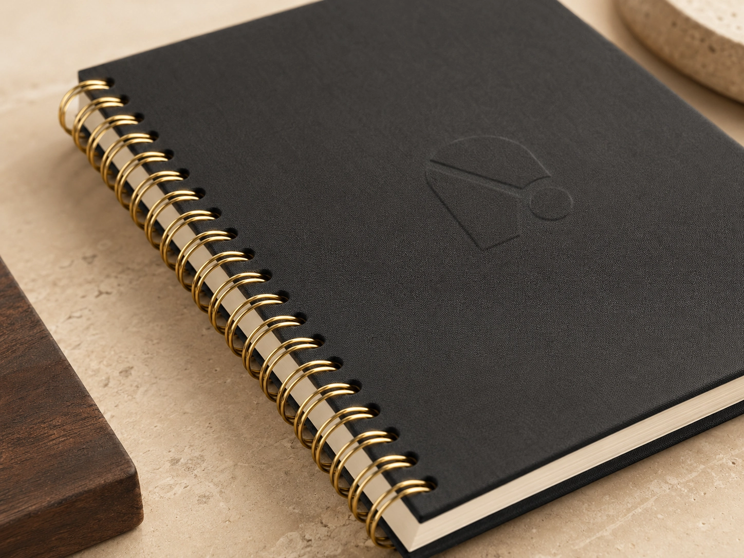 Electroplated gold wire-o binding spine installed on a premium branded custom notebook showing metallic finish detail Electroplated gold wire-o binding spine installed on a premium branded custom notebook showing metallic finish detail